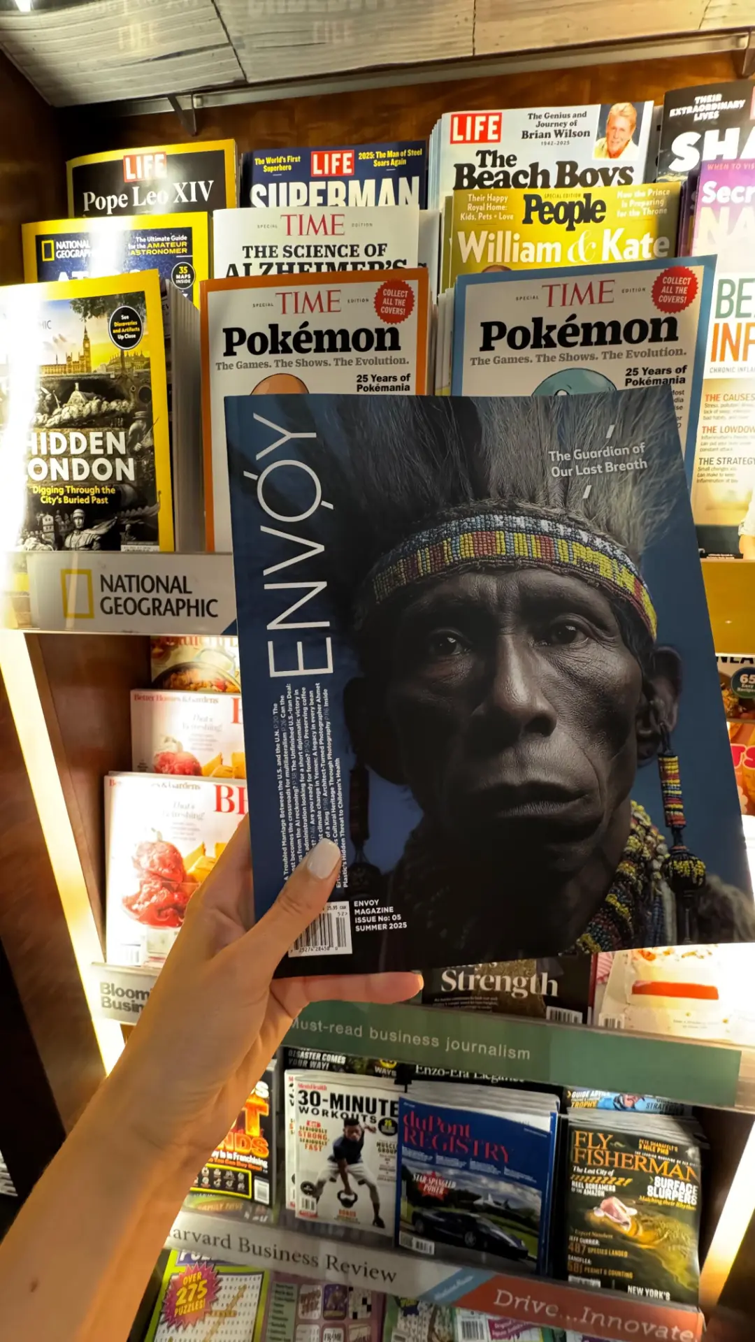 Envoy Magazine Issue 05, Summer 2025, at a newsstand alongside TIME and National Geographic.
